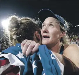  ?? Robert Gauthier Los Angeles Times ?? KERRI WALSH JENNINGS, right, hugs April Ross after winning her fourth Olympic medal in beach volleyball, her first one that wasn’t gold.