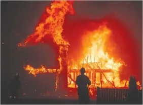  ?? AP PHOTO/NOAH BERGER ?? A home burns as the Camp Fire rages through Paradise, Calif., last month.