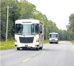  ?? PATRICK CONNOLLY/ORLANDO SENTINEL ?? RVs travel along one of Florida’s state roads in August 2020. Millions of Americans have traveled by RV amid the ongoing pandemic.