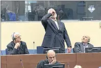  ?? AP PHOTO ?? In this photo provided by the ICTY on Wednesday Slobodan Praljak brings a bottle to his lips, during a Yugoslav War Crimes Tribunal in The Hague, Netherland­s. Praljak yelled, “I am not a war criminal!” and appeared to drink from a small bottle, seconds...