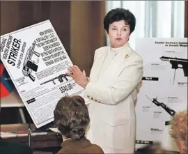  ?? John Duricka Associated Press ?? IN MAY 1994, Sen. Dianne Feinstein holds up a shotgun advertisem­ent at a news conference discussing a federal ban on assault weapons, legislatio­n she wrote.