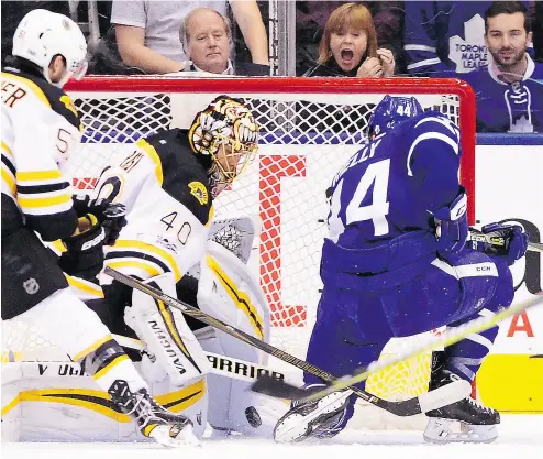  ?? FRANK GUNN / THE CANADIAN PRESS ?? Maple Leafs defenceman Morgan Rielly puts the puck past Bruins goalie Tuukka Rask in Toronto’s win Monday night.