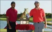  ?? AP PHOTO/DANTE CARRER ?? Jon Rahm, right, poses with Tiger Woods after Rahm won the Hero World Challenge at Albany Golf Club in Nassau, Bahamas, on Sunday.