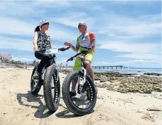  ??  ?? GET ON THE BIKE: Sarah Dirsuwei chats to Mike Glover from Red Cherry Adventures which runs Fat Attack Beach Trails in Port Elizabeth