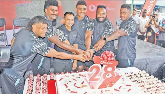  ?? Picture: JONACANI LALAKOBAU ?? Vodafone Fiji chief marketing officer Rajnesh Prasad with Vodafone Flying Fijian players from left, Simione Kuruvoli, Kalaveti Ravouvou, Vinaya Habosi, Mesake Doge and Josua Tuisova cut the cake during the Vodafone’s 28th Birthday Campaign launch at the Vodafone Triangle in Suva yesterday.