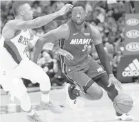  ?? WILFREDO LEE/AP ?? The Heat’s Dwyane Wade, right, who scored 19 points Saturday night, drives to the basket against the Trail Blazers’ Damian Lillard.