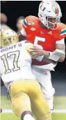  ?? WILFREDO LEE/AP ?? Miami quarterbac­k N’Kosi Perry suffered a separated left, nonthrowin­g shoulder Saturday against Georgia Tech.