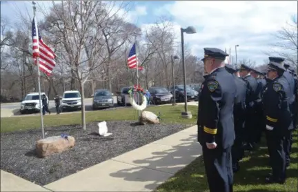  ?? KEITH REYNOLDS — THE MORNING JOURNAL ?? Elyria police officers stand at attention March 15, during the wreath laying ceremony in memory of police Sgt. James Kerstetter, who was killed in the line of duty in March 2010.