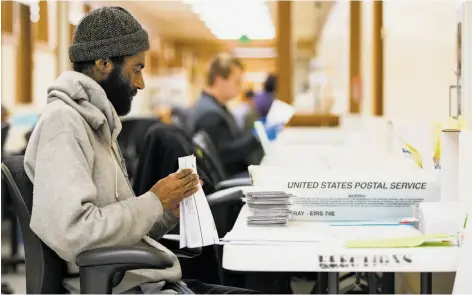  ?? Stephen Lam / Special to The Chronicle ?? A worker prepares ballots for counting June 7 in San Francisco. The city needs to find a way to determine election winners faster.