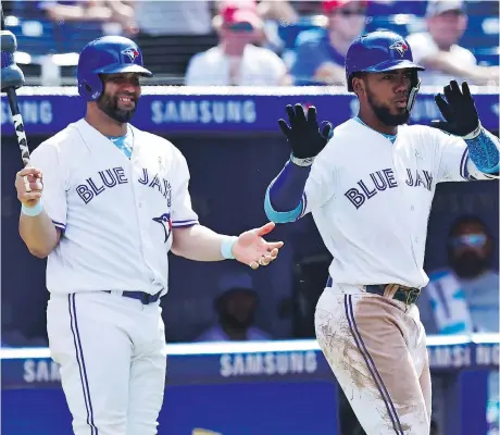  ?? FRANK GUNN/THE CANADIAN PRESS ?? Blue Jays left fielder Teoscar Hernandez, right, celebrates his solo home run against the Washington Nationals as Kendrys Morales looks on in the eighth inning Sunday in Toronto.