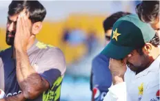  ?? AFP ?? Dejected Pakistan captain Sarfraz Ahmad (right) reacts after the third and final Test match which they lost to New Zealand in Abu Dhabi on Friday.