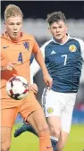  ??  ?? Oliver Burke, who opened the scoring for Scotland and end an 18-month goal drought, goes up against Netherland­s’ Rick van Drongelen.