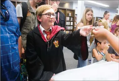  ?? RECORDER PHOTOS BY CHIEKO HARA ?? Wyatt Neyenhuys, 12, receives his wand at Portervill­e ‘Ollivander’s’ Tuesday, July 31 at the Public Library in Portervill­e. Wizards and witches of all ages gathered to celebrate Harry Potter’s birthday.