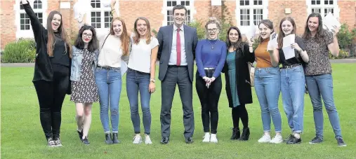  ??  ?? Our Lady’s Convent School more than tripled the proportion of A* grades achieved in this year’s A-Levels and 29 per cent of grades achieved were A*-A. Pictured is headmaster Dr Julian Murphy celebratin­g with students from Our Lady’s Convent School...