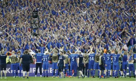  ?? CHRISTIAN HARTMANN/REUTERS ?? Iceland players leave the pitch to the adoration of their fans following Wednesday’s 2-1 victory over Austria at the European Championsh­ip.