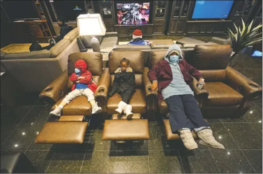  ?? (AP/David J. Phillip) ?? Joecyah Heath (from left), Morning Day and Jenesis Heath rest in recliners at a Gallery Furniture store which opened as a shelter in Houston.