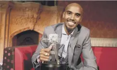  ??  ?? Mo Farah with the Sports Personalit­y of the Year trophy on Sunday.