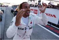  ?? Reuters ?? Mercedes’ Lewis Hamilton celebrates after winning the Japan F1 race on Sunday. The Briton leads Vettel by 67 points. —