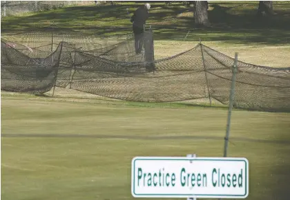  ?? DAVID BLOOM ?? A golfer sneaks in a few practice swings at the Victoria Golf Course in Edmonton on Friday. Courses allowed to reopen starting today.