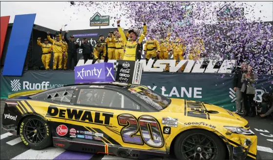  ?? CHUCK BURTON — THE ASSOCIATED PRESS ?? Christophe­r Bell celebrates in Victory Lane after winning the NASCAR Cup race at Martinsvil­le Speedway on Sunday.