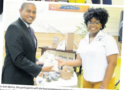  ??  ?? Jo-Ann Morris, the participan­t with the best entreprene­urial
State in the Ministry of Industry, mindset, smiles as she makes a sale to Minister of Commerce, Agricultur­e and
Fisheries, Floyd Green.