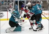  ?? JOSIE LEPE — THE ASSOCIATED PRESS ?? San Jose Sharks goaltender James Reimer (47) makes a save with the help of defenseman Mario Ferraro (38) against New Jersey Devils left wing Tomas Tatar (90) during the second period Saturday in San Jose.