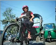  ?? AFP ?? Mosammat Jasmine, Bangladesh’s lone female rickshaw driver, poses on her battery-run vehicle in Chittagong.