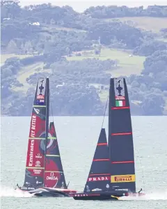  ?? AFP ?? Team New Zealand, left, and Luna Rossa practise in Auckland.