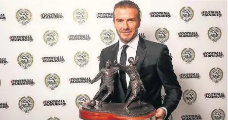  ??  ?? David Beckham with his PFA award, left; and, right, Peter Mook after completing his work for the presentati­on ceremony – ‘I was hoping to go to the ceremony and meet Beckham,’ he says, ‘but by the time they got round to sorting it out, there were no...