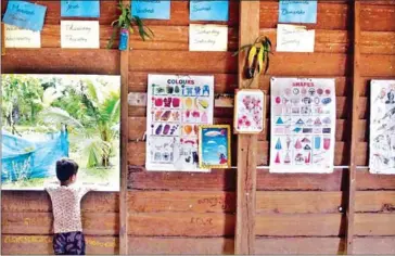  ?? GEORGE NICKELS ?? A student looks out the window at a school in Siem Reap province in 2014 where the director was arrested for traffickin­g students.