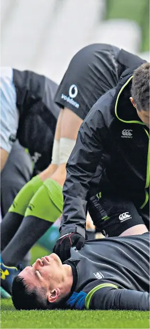  ??  ?? Sore point: Johnny Sexton receives treatment at the Aviva yesterday