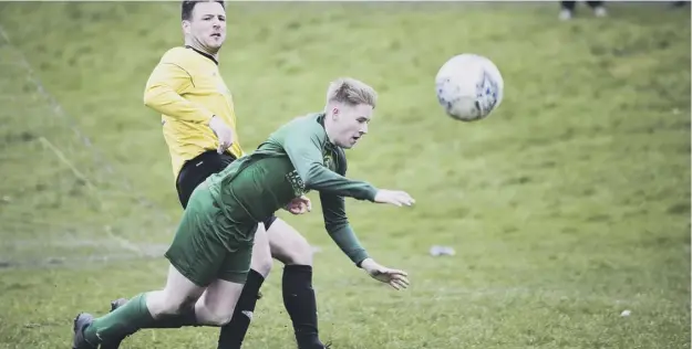  ??  ?? UNDER PRESSURE: Matthew Whitworth in action for Sowerby United (in green), who face a crunch clash with Illingwort­h St Mary’s this Saturday.