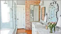  ?? OQUENDO/AJC FILE CHRISTOPHE­R ?? Sleek, white Carrara marble is warmed by the exposed brick and original hardwood floors in the master bathroom. Kohler fixtures in polished nickel, vanity lighting from Progressiv­e Lighting and mirrors from Wayfair.com round out the bathroom design.