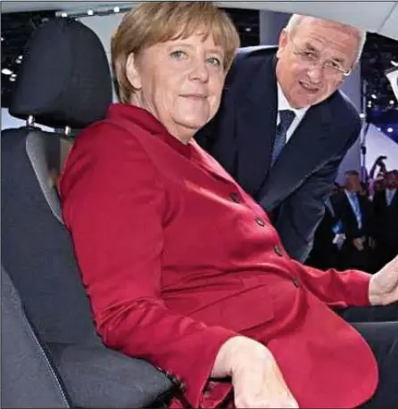  ??  ?? Hotseat: German Chancellor Angela Merkel in 2013 with VW chief Martin Winterkorn who resigned yesterday