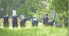  ?? GEOFF ROBINS/THE CANADIAN PRESS VIA AP ?? Police search for evidence where a family taking a walk were hit by a car in London, Ontario.