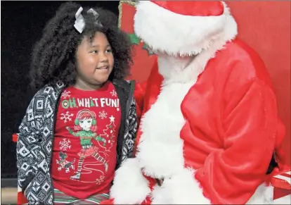  ?? Daniel Bell ?? Shyana Starr talks to Santa Claus during a Christmas party at the Boys and Girls Club in Calhoun on Saturday.