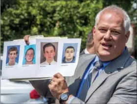  ?? CLEM MURRAY — THE PHILADELPH­IA INQUIRER VIA AP ?? Bucks County District Attorney Matthew Weintraub holds up photos of four men who are missing during a news conference in Solebury Township, Pa., Monday. The four men, who went missing last week, are Dean Finocchiar­o, from left, Tom Meo, Jimi Tar...