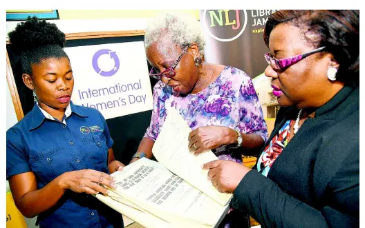  ?? RUDOLPH BROWN/PHOTOGRAPH­ER ?? Linnette Vassell (centre), founding member of CWP, hands over maternity leave documents to Beverly Lashley (right), national librarian of the National Library of Jamaica, and Monique Forgie Scott, manager, collection­s at the National Library, at the organisati­on’s East Street headquarte­rs on Friday.