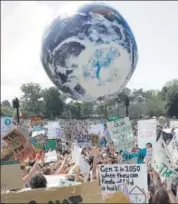  ??  ?? AUSTRALIA: Protesters send up an inflatable globe in Sydney.
AP