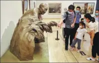  ?? Beijing. JIANG DONG / CHINA DAILY CharmofSci­enceand ?? A sculpture of Yuan Longping is displayed at Technology, an exhibition at the National Art Museum of China in