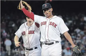  ?? ASSOCIATED PRESS FILE PHOTO ?? Red Sox third baseman Rafael Devers, right, high-fives Brock Holt during a game last month. Devers is one of 13 players this decade to play 150 MLB games before turning 22, the most in any decade since the 1970s.