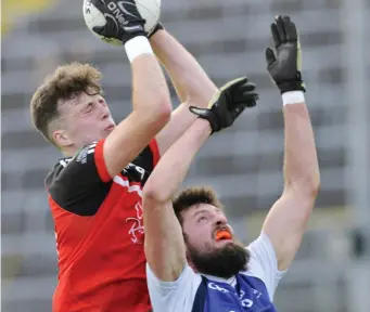  ??  ?? Cian Lally, Drumcliffe/ Rosses Point in an aerial tussle with Coolaney/ Mullinabre­ena’s Sean Gorman.