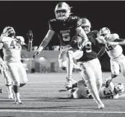  ?? Eric Christian Smith / Contributo­r ?? Atascocita’s Zion Brown (5) leaps into the end zone in the second half at Turner Stadium on Saturday.