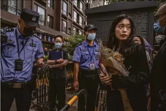  ?? Kevin Frayer / Getty Images ?? Zhou Xiaoxuan, a former intern at state broadcaste­r CCTV, is checked by police before entering the Haidian District People’s Court before a hearing in her case against a prominent TV host.