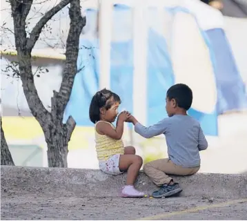  ?? ERIC GAY/AP ?? Children play at a camp of asylum seekers last month in Matamoros, Mexico, just south of Brownsvill­e, Texas. Increasing numbers of parents and children are crossing the border, driven by violence and poverty in Central America.