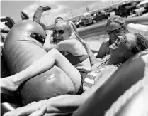  ?? SEAN GARDNER/GETTY IMAGES ?? Fans relax in a pool as they try to keep cool before Saturday night’s Coke Zero Sugar 400 at Daytona Internatio­nal Speedway.