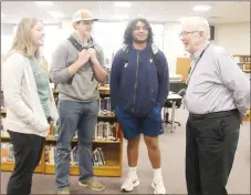  ?? Lynn Kutter/Enterprise-Leader ?? John Wyatt, 83, a full-time substitute teacher at Prairie Grove High School, visits with Reese Light, his granddaugh­ter, Corbin Bowlin and James Moss in the Prairie Grove High School library. Wyatt has subbed in Prairie Grove for 16 years.