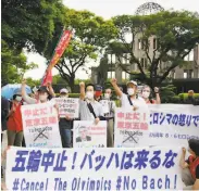  ?? / Kyodo News via Associated Press ?? Protesters gather near the Atomic Bomb Dome with a message for IOC President Thomas Bach.