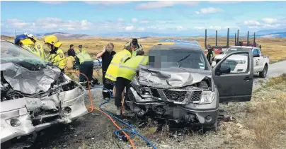  ?? PHOTO: SUPPLIED ?? Grim task . . . Emergency services personnel attend the scene of a crash near Tekapo yesterday in which three people died.