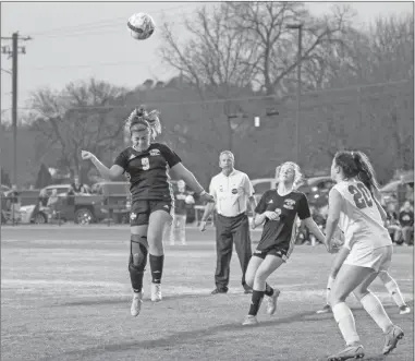  ?? Tim Godbee ?? Calhoun senior defender Jasmine Yarissa Rodriguez heads the ball in a crowd of people during a recent Yellow Jackets Region contest.